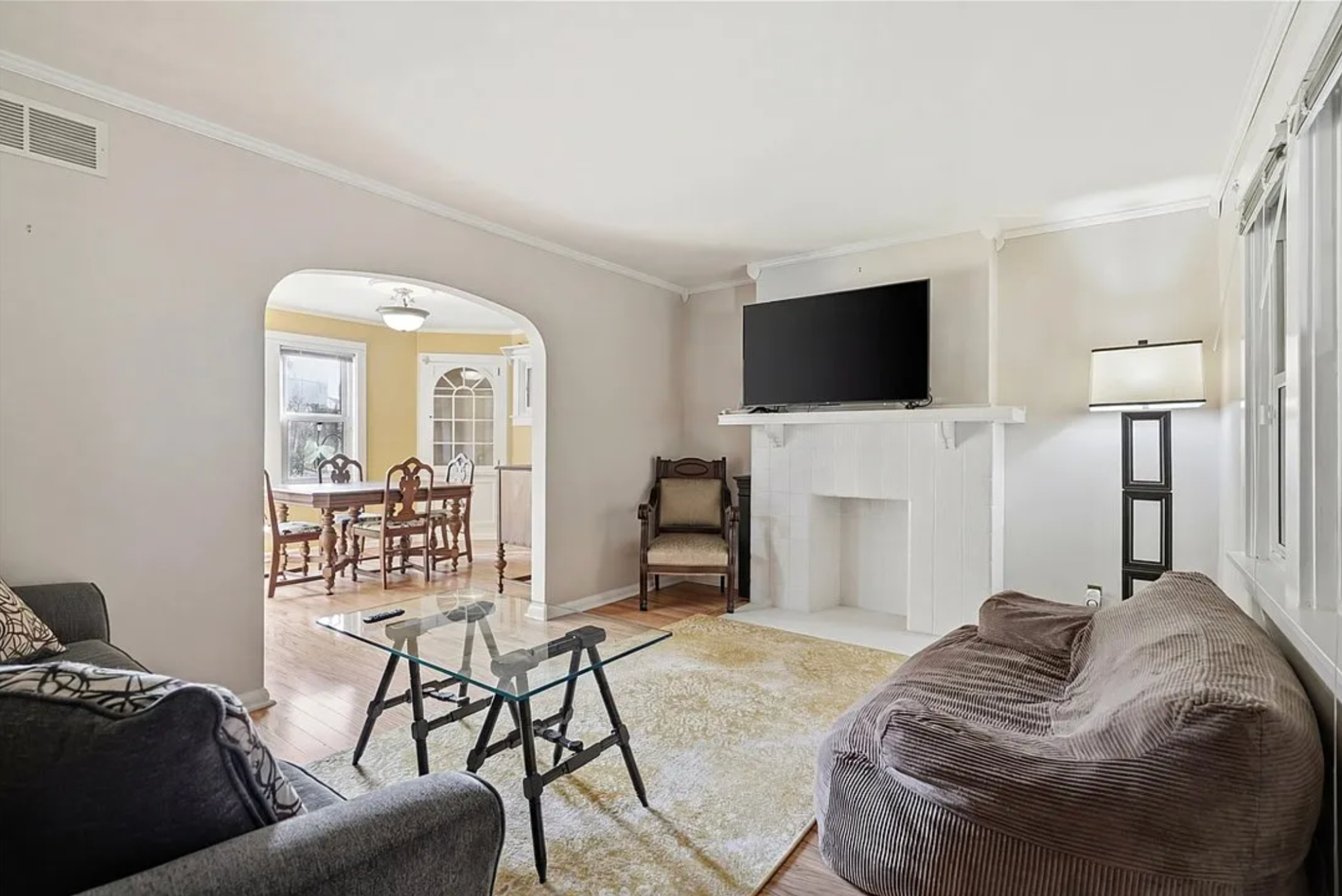Living room before — mismatched furniture, dated styling, no coherent design identity